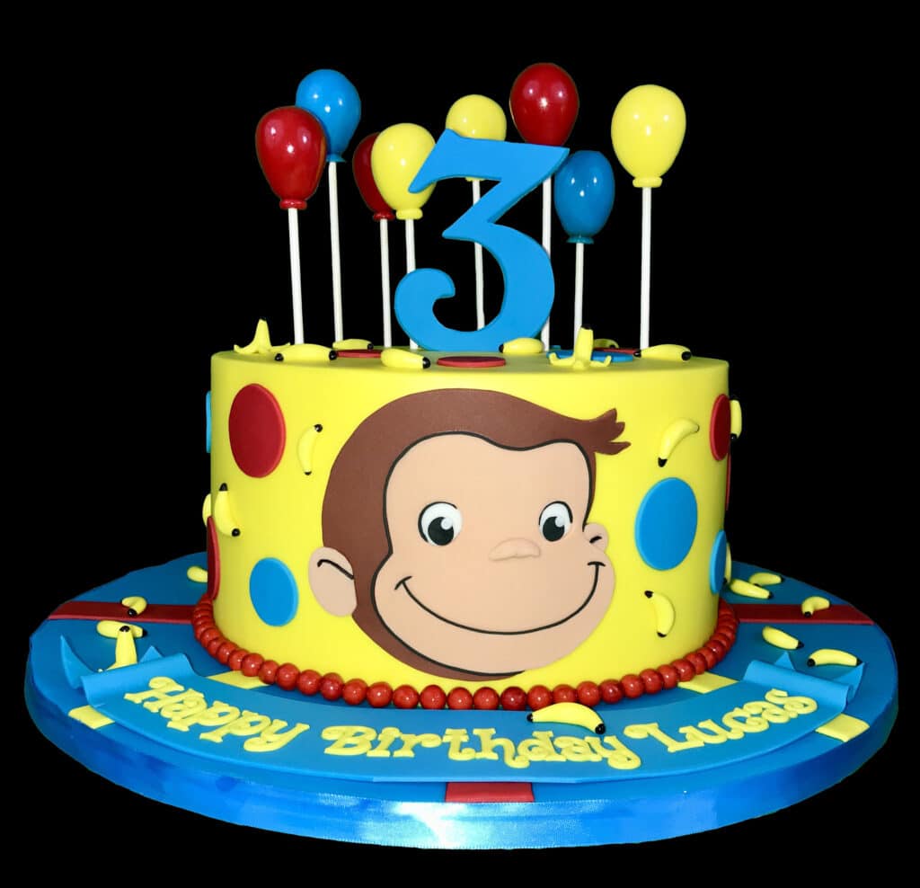 Simple Curious George Birthday Cake with edible fondant George face and colorful balloon shaped lollypops