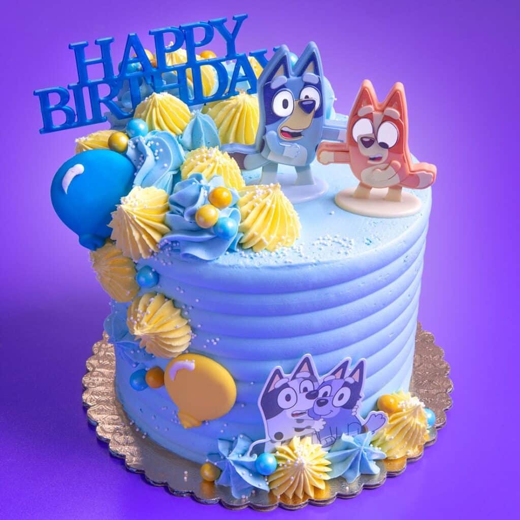 Bluey Blue Birthday Cake with Bluey and Bingo Cake topper and edible fondant balloon.