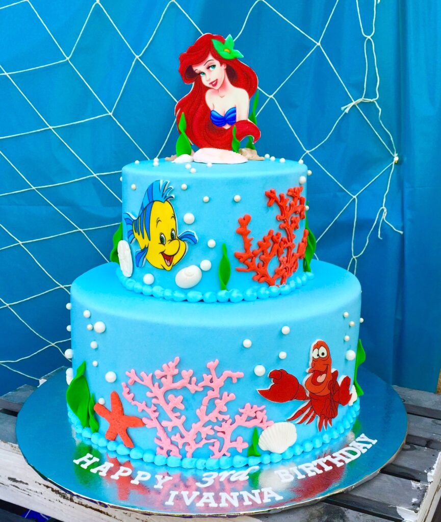 Blue Icing Ariel Little Mermaid Themed Birthday Cake with edible seashell, seaweed, flounder an sebastian