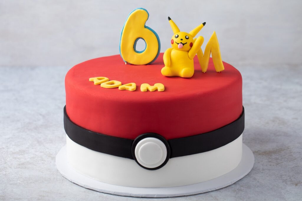 Pokeball Cake with white and red frosting and edible fondant Pikachu